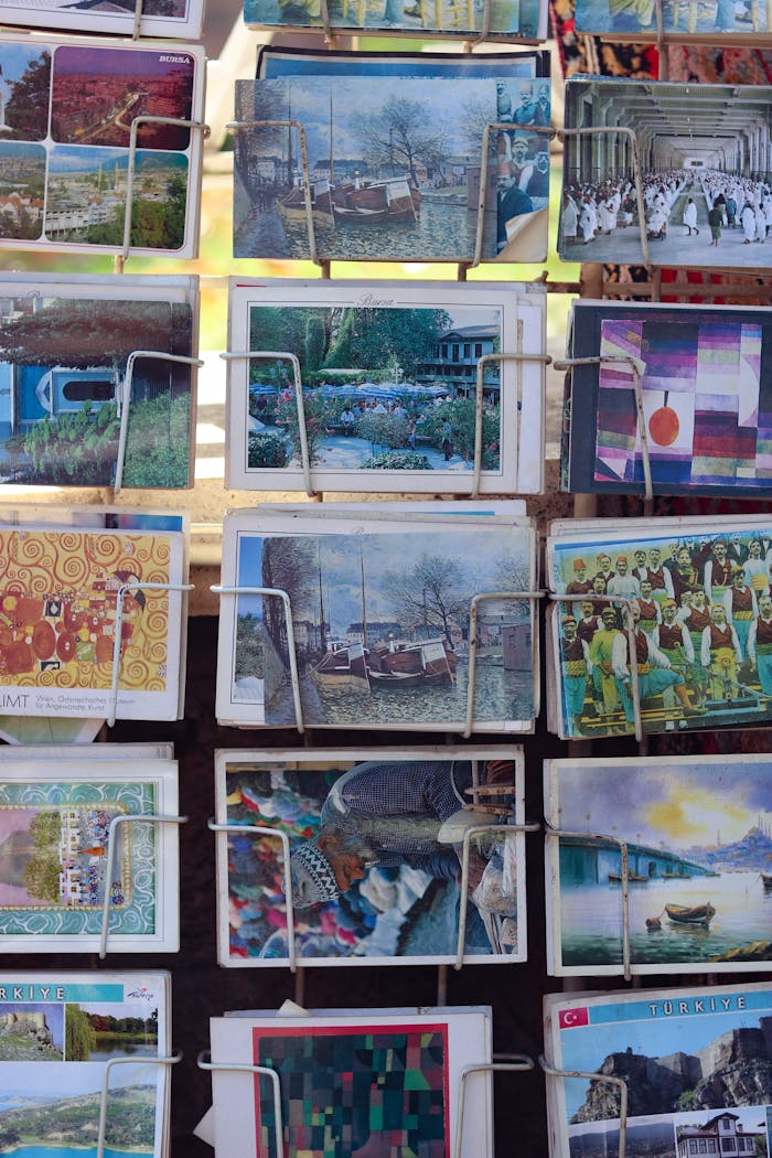 Vibrant postcards featuring various scenes on a retail display stand.