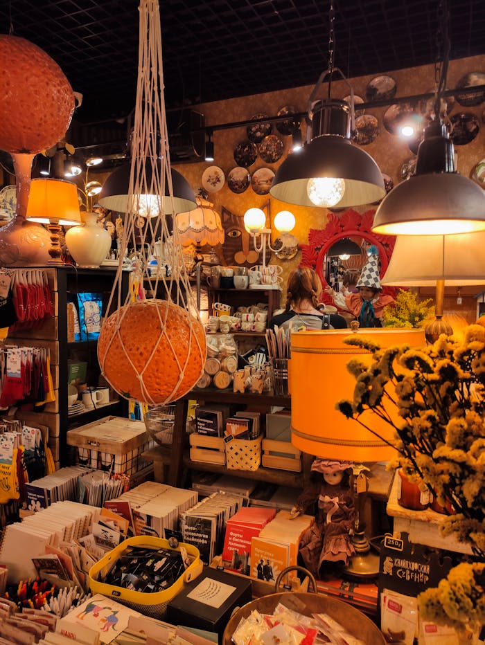 Explore a cozy vintage store filled with warm lighting, books, and unique decor items.